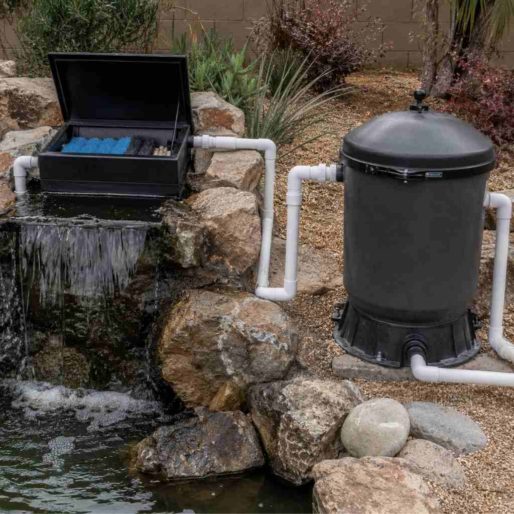 : Open waterfall box filter showing limited media volume compared to a larger pressurized bead filter, demonstrating the filtration capacity difference